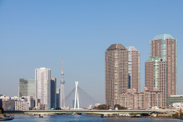 High-rise buildings against blue sky in Tokyo