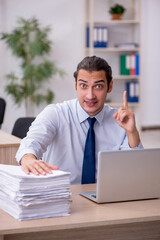 Naklejka premium Young male employee sitting in the office