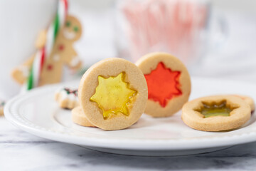Christmas butter stained glass window cookies in hand