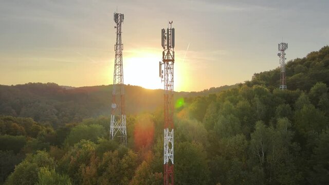 5G Technology Telecommunication Antenna Towers at Beautiful Sunrise. Electromagnetic Radiation and Pollution in Clean Unpolluted Nature. Aerial Orbit Shot