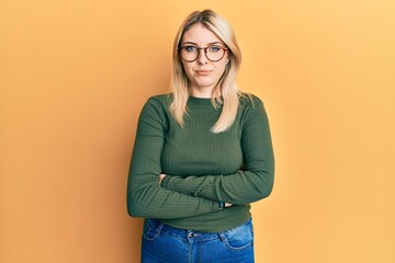 Young caucasian woman with arms crossed gesture skeptic and nervous, frowning upset because of...