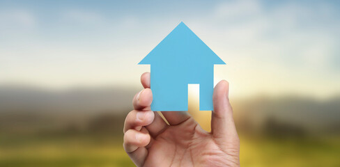 Naklejka premium Hands holding paper house, family home protecting insurance concept