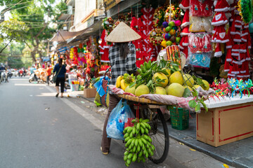Fruit vendor on Hanoi old town street at early morning