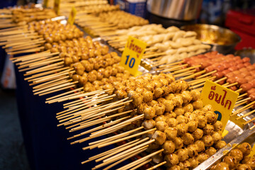 Thai street food skewers, text of signs means 