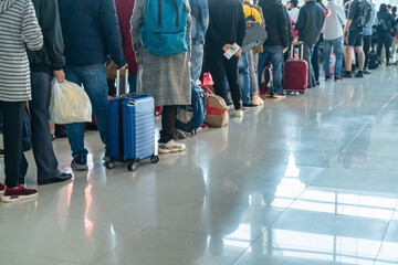 Line of Asian people waiting at boarding gate at airport