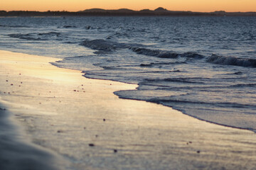 soft wave on the beach at sunset