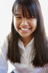 toothy smiling face of asian teenager
