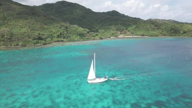 4K Aerial video of sail boat sailing in paradise blue water lagoon
