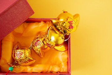 Lunar New Year decoration with lucky gold bar isolated on yellow . Tet Holiday.Translation of text appear in image: fortune good luck