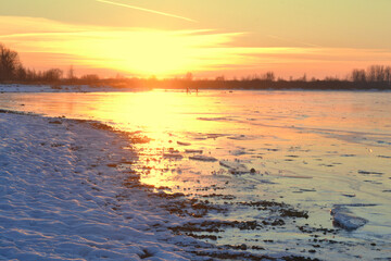 Fototapeta na wymiar Winter Sea Sunset. Walk on the ice dunes of a frozen lake in win
