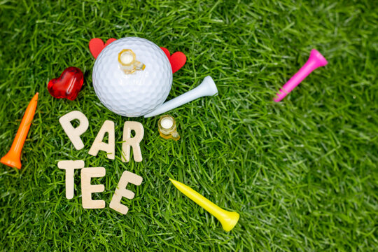 Golf Party with golf ball and tee on green grass