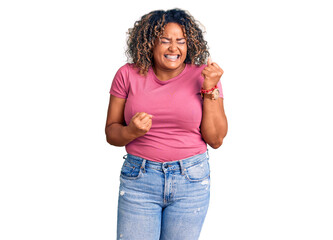 Young african american plus size woman wearing casual clothes celebrating surprised and amazed for success with arms raised and eyes closed. winner concept.