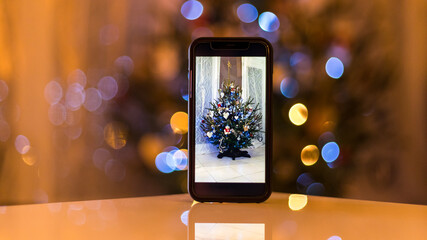 Christmas tree on a phone on the table