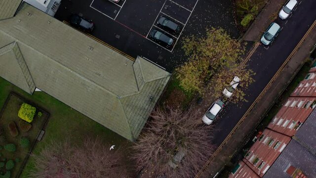 Aerial pan up reveal shot from residential area to central London skyscrapers