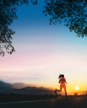 Young woman is running an outdoor workout on road in the morning.