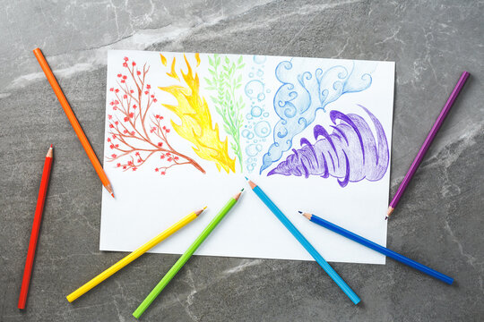 Colored pencils drawing rainbow smoke. Flat lay