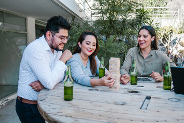 Hispanic business people having fun playing in creative office terrace in Mexico city