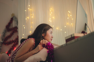 Side view - Lonely asian girl celebrate christmas party online with people on computer.