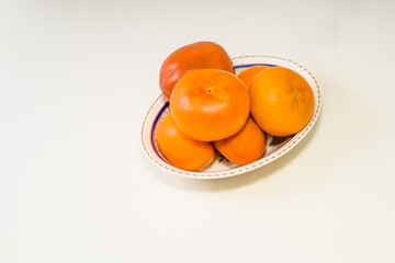 The persimmon is the edible fruit of a number of species of trees in the genus Diospyros