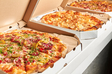 Pizza in open boxes prepared for delivery