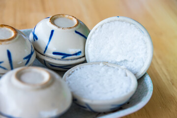Close up coconut milk custard in small porcelain cup.