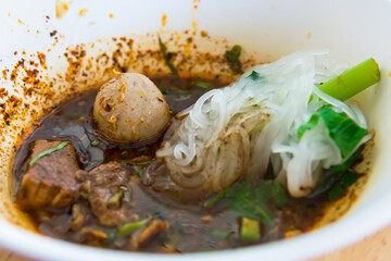 Popular street food in Thailand (Kuai Tiao Moo Namtok) that consisted of pork ball, pork meat, basil or thyme, bean sprouts, morning glory, noodle and creamy soup.