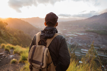 Portrait adventurous man with a backpack enjoying the mountain scenery