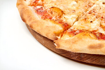 Pizza with cheese and tomatoes on wooden board. Close-up, selective focus.