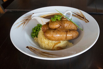 Bangers and Mash with peas and gravy