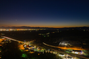 Dark small town at night with mountains as background