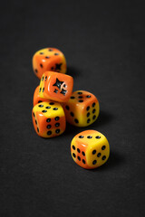 Closeup of six orange cubes on black casino table