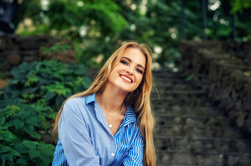 Fototapeta premium Portrait of a young happy woman on the street of a European city