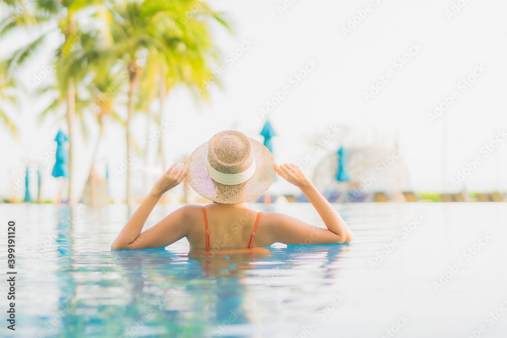 Wall mural portrait beautiful young asian woman relax smile leisure around outdoor swimming pool nearly sea bea