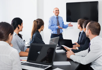 Manager making speech during business meeting in office