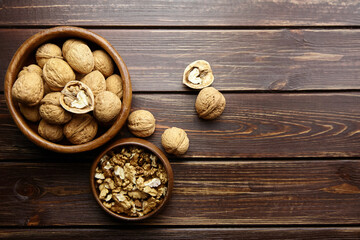 Walnut half and seeds and bowl on wooden table