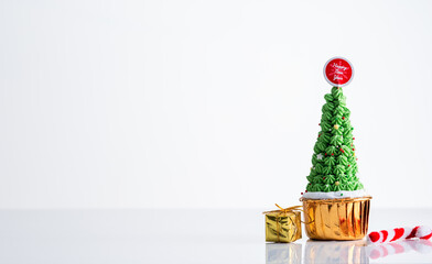 Christmas cupcake, pudding on white table Traditional New Year dessert. Copy space.,x'mas Cake decoration and gift box with Christmas tree concept for banner cover background