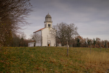 Church of Virgin Mary in Obersljan or Device Marije Obrsljanske close to Komen in the middle of the Karst. Typical karst church in slovenia between the vineyards.