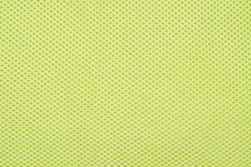 Bright green fabric upholstery of the chair. The view from the top.