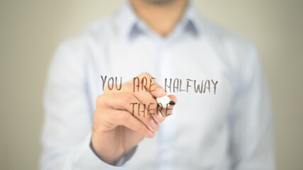 You Are Halfway There , man writing on transparent screen