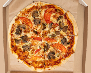 Pizza with mushrooms in a cardboard box. Food
