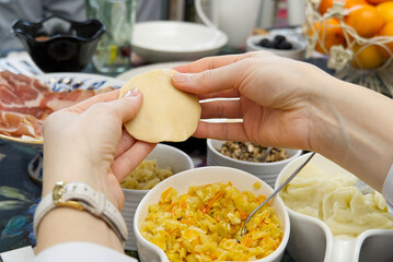 Woman cooking tasty dumplings, close up. diy homemade dumplings with different fillings. potato dumplings