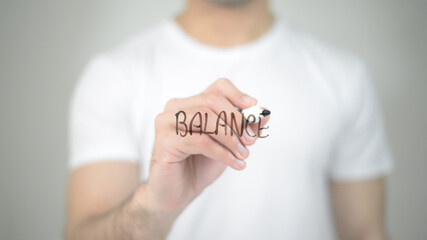 Balance, man writing on transparent screen