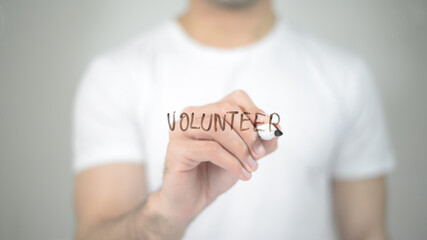 Volunteer, man writing on transparent screen