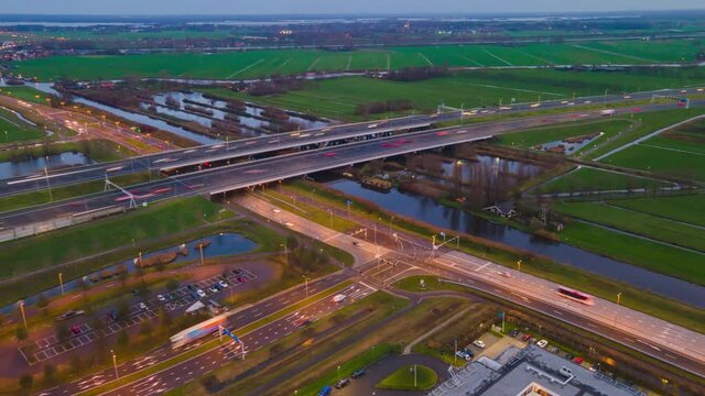 Aerial hyperlapse timelapse of the A2 motorway highway infrastructure by night dusk in the Netherlands. Between Utrecht and Amsterdam at Vinkeveen europe.