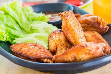 Traditional Thai fired chicken wing close up.