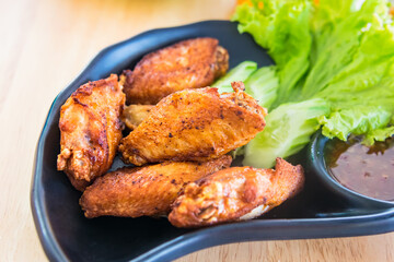 Traditional Thai fired chicken wing close up.
