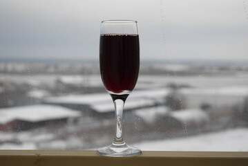 wineglass with red wine on table