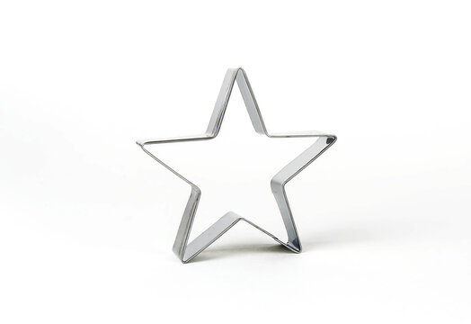 Star shaped metal cookie cutter on a white background.