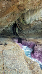 The Pink Cave at Catherine Hill Bay near Moonee Beach New South Wales Australia. A sea cave with an amazing pink rock band visible at low tide