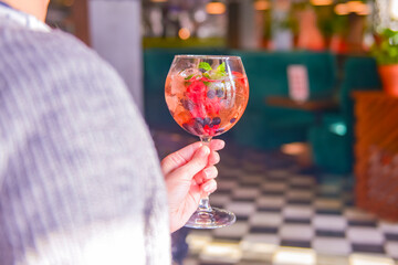Raspberry Cocktail with ice and berry. Refreshing cocktail with berries inside. Delicious alcohol drink.